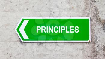 Green sign on a concrete wall - Principles