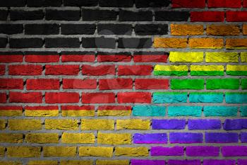 Dark brick wall texture - coutry flag and rainbow flag painted on wall - Germany