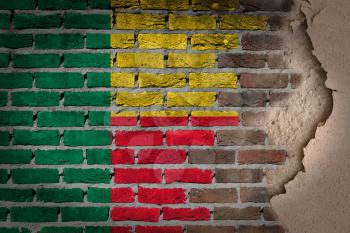 Dark brick wall texture with plaster - flag painted on wall - Benin