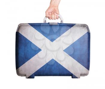 Used plastic suitcase with stains and scratches, printed with flag, Scotland