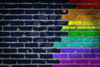 Dark brick wall texture - coutry flag and rainbow flag painted on wall - Alaska