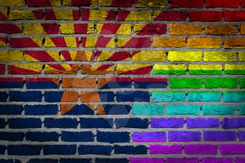 Dark brick wall texture - coutry flag and rainbow flag painted on wall - Arizona