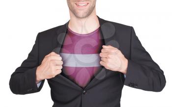 Businessman opening suit to reveal shirt with flag, Latvia