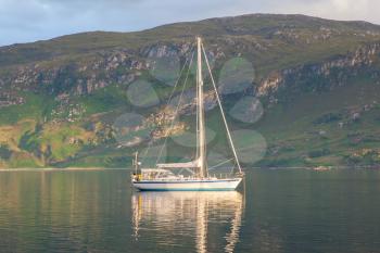 Sailboat sailing in a loch in Scotland