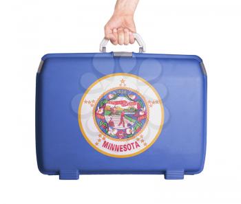 Used plastic suitcase with stains and scratches, printed with flag, Minnesota