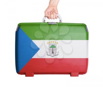 Used plastic suitcase with stains and scratches, printed with flag, Equatorial Guinea