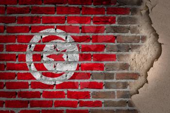 Dark brick wall texture with plaster - flag painted on wall - Tunisia