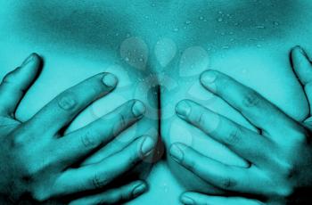 Upper part of female body, hands covering breasts, blue