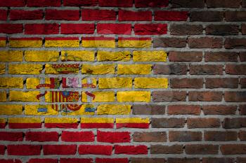Very old dark red brick wall texture with flag - Spain