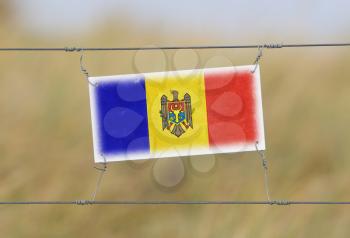 Border fence - Old plastic sign with a flag - Moldova