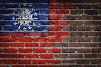 Very old dark red brick wall texture with flag - Myanmar
