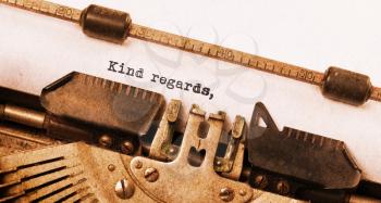 Vintage typewriter, old rusty, warm yellow filter, kind regards