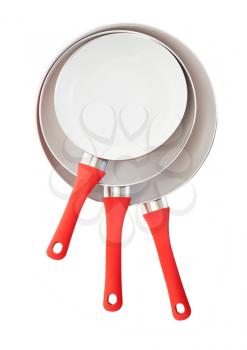 Set of three frying pans, isolated, close-up, red