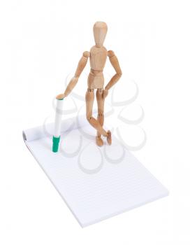 Wooden mannequin writing in a scrapbook, isolated