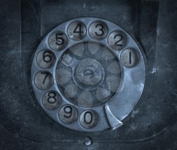 Closeup of vintage telephone dial, scratched and filthy