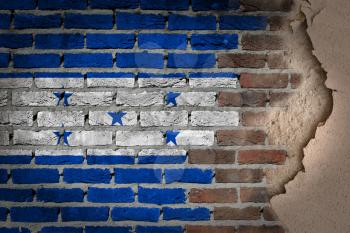 Dark brick wall texture with plaster - flag painted on wall - Honduras