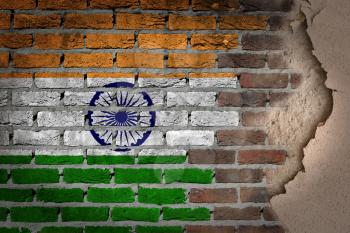 Dark brick wall texture with plaster - flag painted on wall - India