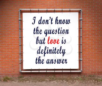 Large banner with inspirational quote on a brick wall - I don't know the question...