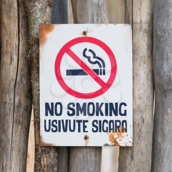 Old no smoking sign, hanging on a fence