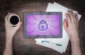 Tablet on a desk, concept of data protection, purple