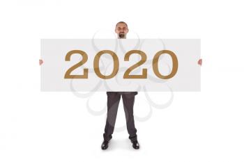 Smiling businessman holding a really big blank card - 2020, isolated on white
