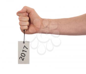 Hand holding a tag, isolated on white - New year - 2017