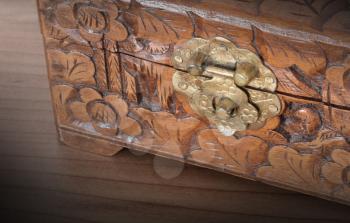 Very old wooden chest with simple lock, selective focus