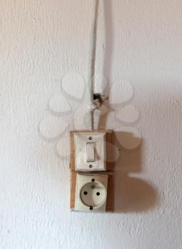 Wall socket and light switch on a wall