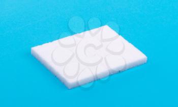 White sugar cubes on a blue solid background