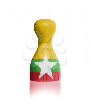 Wooden pawn with a painting of a flag, Myanmar