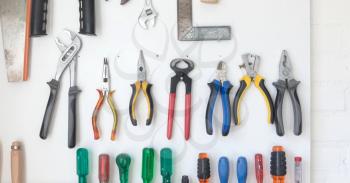 Assorted tools on a white tool board - Simple setting