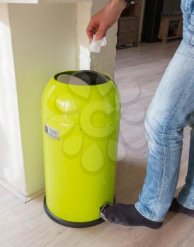 Green trash can in a dutch house