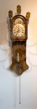 Brass weight on an old dutch clock - Selective focus