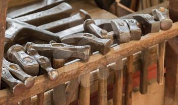 Collection of vintage woodworking tools on a rough workbench - Hammers - Selective focus