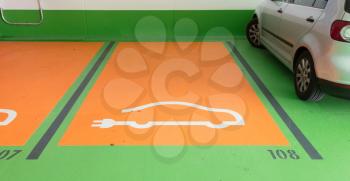 Electric vehicle charging station and parking stall sign paint on asphalt