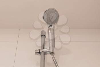 Shower head on a tiled wall - Waiting to be used
