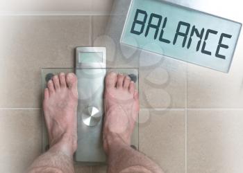 Closeup of man's feet on weight scale - Balance