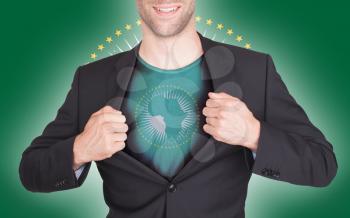 Businessman opening suit to reveal shirt with flag, African Union
