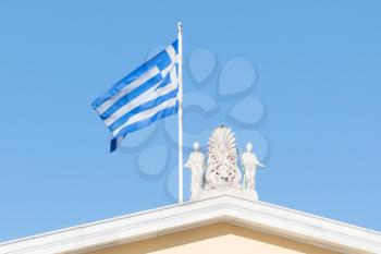 Greek flag waving under clear sky - Athens