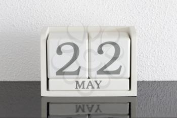 White block calendar present date 22 and month May on white wall background