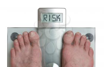 Closeup of man's feet on weight scale - Risk