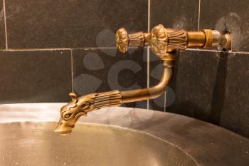 Unique brass faucet - Interior of a sauna