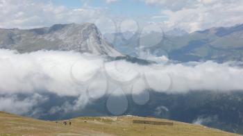 View of beautiful landscape in the Alps - Clouds rolling past the mountains