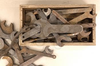 Collection of old rusty wrenches on a dirty floor