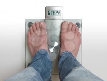 Closeup of man's feet on weight scale - WTF!!!