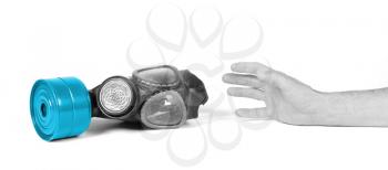 Arm reaching for vintage gasmask isolated on a white background - Blue filter