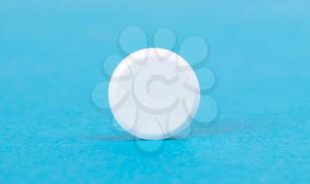 Pill isolated on blue background - Medicine concept