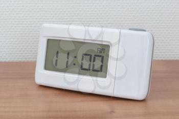 Clock radio on a desk - Time - 11.00 AM
