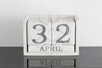 White block calendar present date 32 and month April on white wall background - Extra day