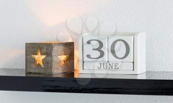 White block calendar present date 30 and month June on white wall background